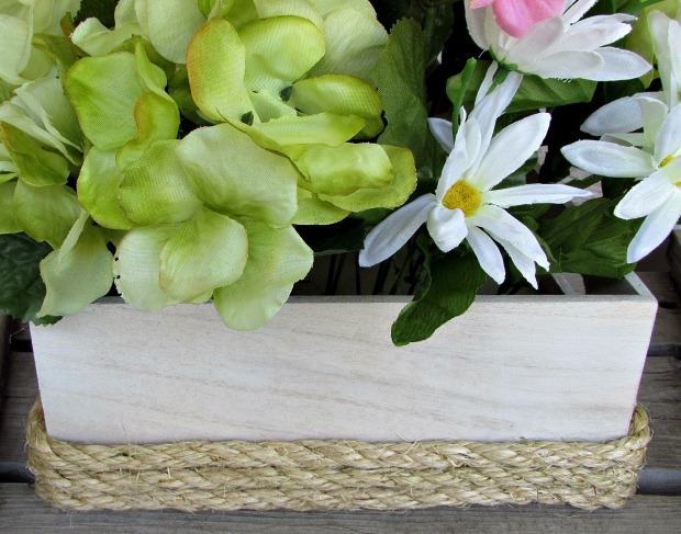 wooden box with flowers and rope