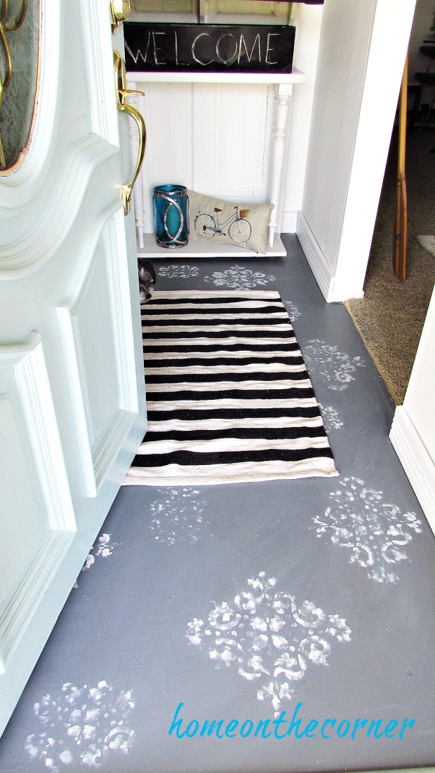 painted entryway floor with striped rug