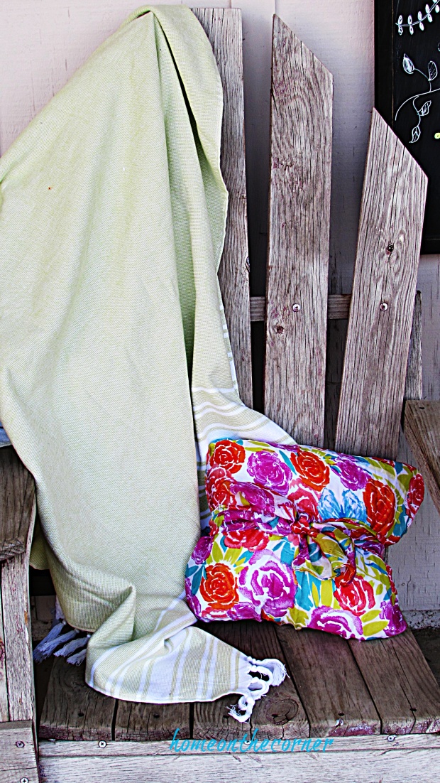 spring porch green blanket and floral pillow