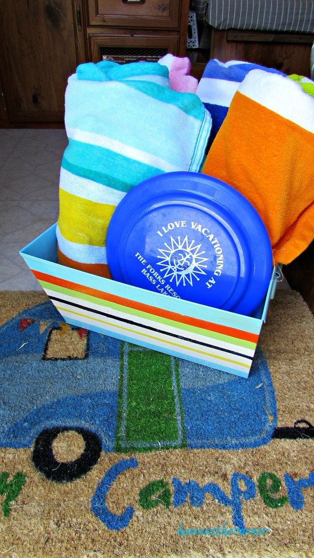 metal box with painted stripes and towels
