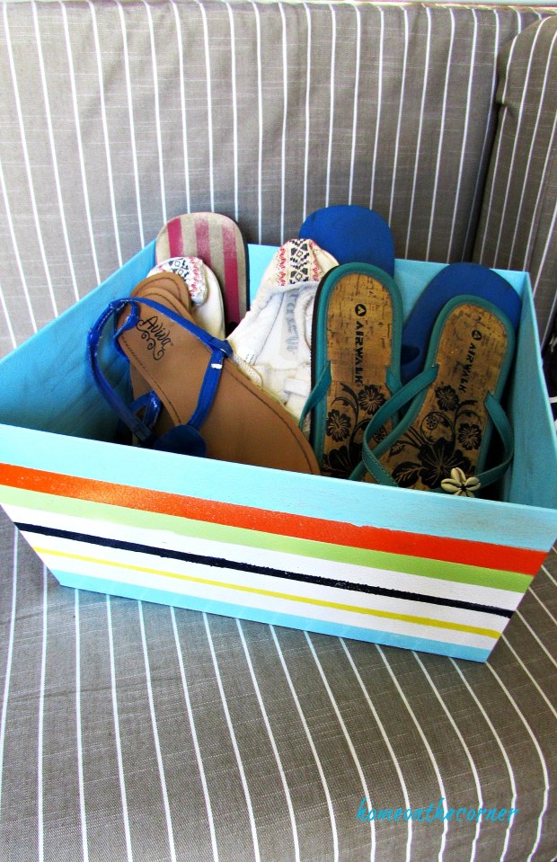metal box with painted stripes storing shoes
