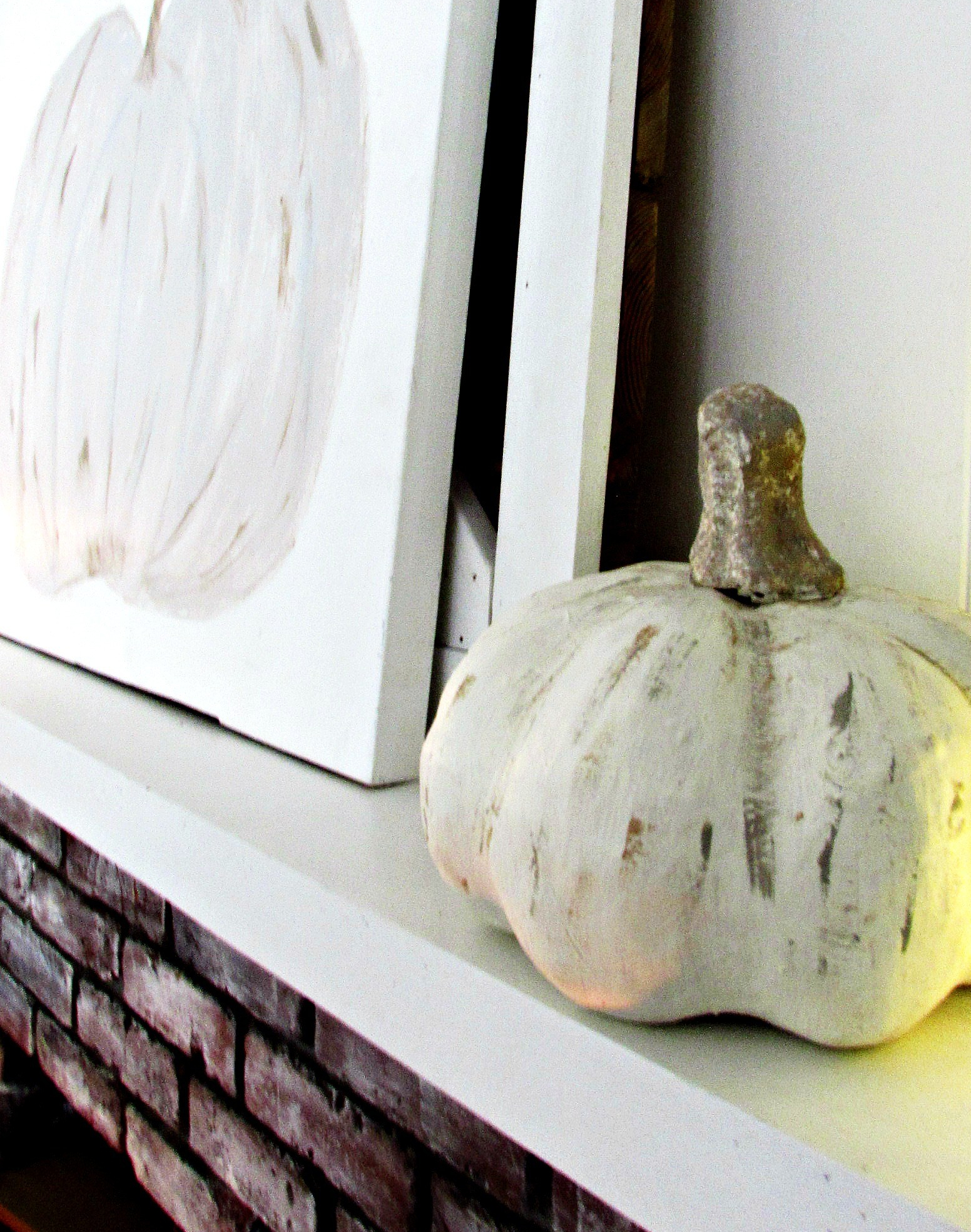 cream pumpkin mantle with painted pumpkin picture